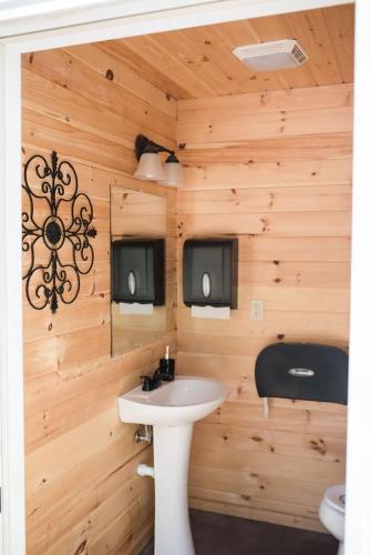 a bathroom with a sink and a toilet at GlampKnox Canvas Campground - Grande in Knoxville