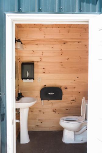 a bathroom with a toilet and a sink at GlampKnox Canvas Campground - Tree Solo in Knoxville