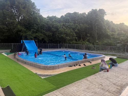 a group of people in a swimming pool at RTMS Guesthouse Semporna in Semporna
