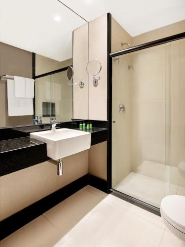 a bathroom with a sink and a shower at NH HOTEL FEIRA DE SANTANA in Feira de Santana