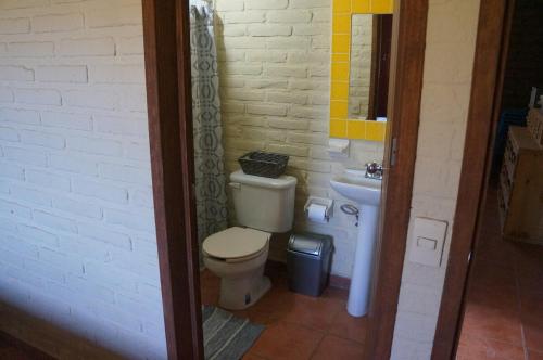 a bathroom with a toilet and a sink at Happy Trails in San Antonio