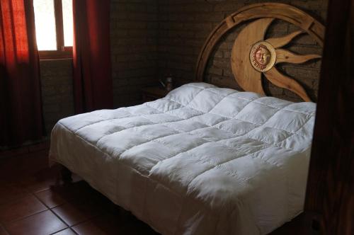 a white bed with a wooden headboard in a bedroom at Happy Trails in San Antonio