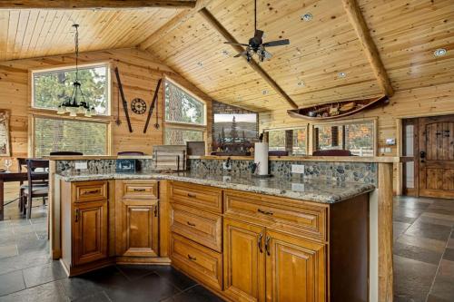 a large kitchen with wooden cabinets and a ceiling at Bear Creek Lodge with Hot Tub in Big Bear Lake