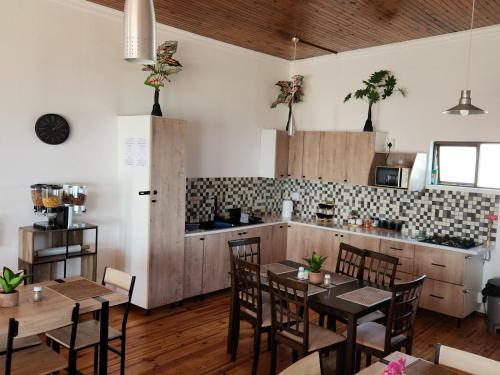 a kitchen and dining room with tables and chairs at Seaview Sunsets in Gqeberha
