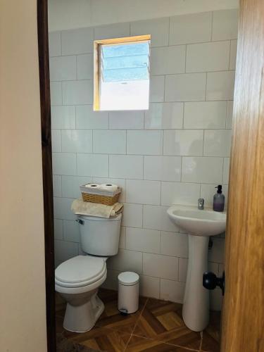 a bathroom with a toilet and a sink at El Descanso Cabins in Capilla Palacio