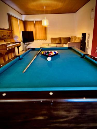 a pool table in a living room with a pool table at 4-bedroom family villa, bath tub, billiards, piano, and fun board games in Rødby
