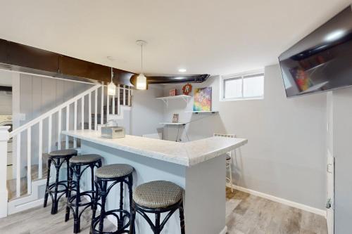 a kitchen with a counter and bar stools at 2 Mi to Beach! Hot Tub Haven in Michigan City in Pottawattamie Park