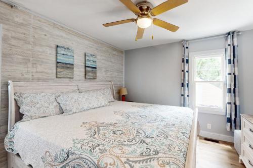 a bedroom with a bed with a ceiling fan at 2 Mi to Beach! Hot Tub Haven in Michigan City in Pottawattamie Park