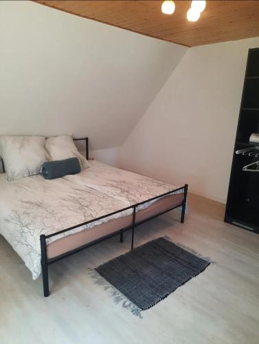a bedroom with a bed with a rug on the floor at Oakwoods in Holste