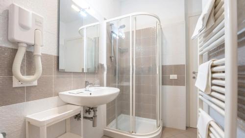 a white bathroom with a sink and a shower at Nuovo Hotel SettiBi in Giulianova