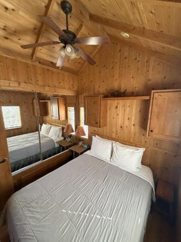 a bedroom with two beds and a ceiling fan at Boulder Creek RV Resort in Lone Pine