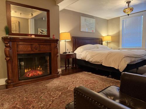 a bedroom with a bed with a fireplace and a mirror at Inn at Harbour Village in Ilwaco