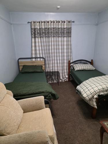 a living room with two beds and a couch at Room near Oxford city centre in Oxford