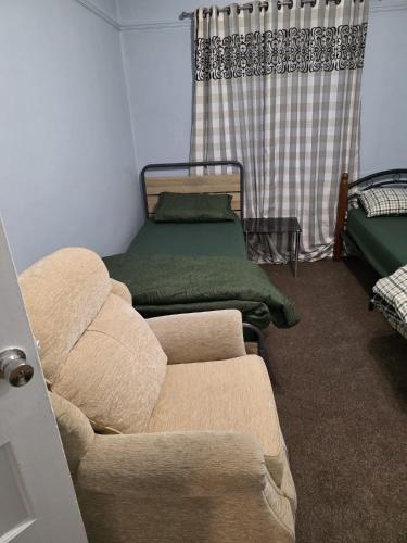 a living room with a couch and a bed at Room near Oxford city centre in Oxford