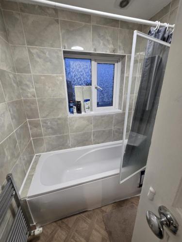 a bathroom with a bath tub and a window at Room near Oxford city centre in Oxford