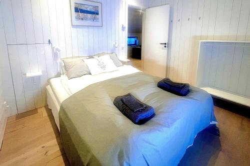 a bedroom with a large bed with two pillows on it at Studio Svartbygget in Åre