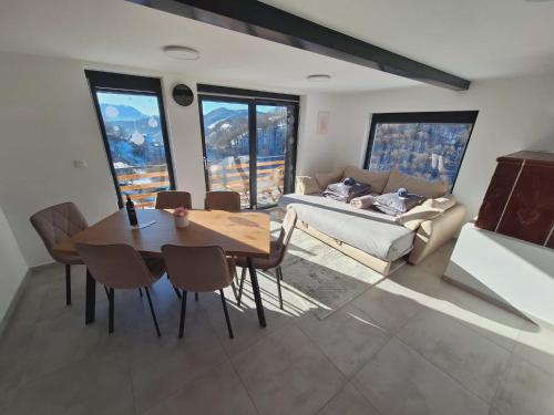 a living room with a table and a couch at En hribček in Ptujska Gora