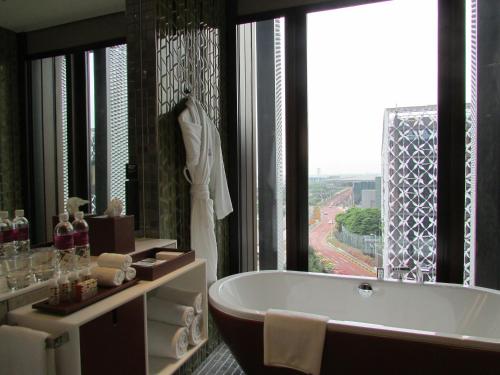 a bathroom with a tub and a large window at Crowne Plaza Changi Airport by IHG in Singapore