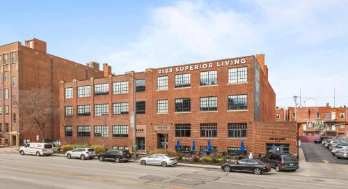 a large brick building with cars parked in a parking lot at 2125 Superior Living in Cleveland