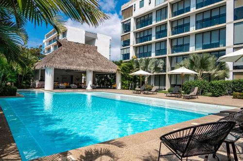 a swimming pool in front of a building at Torres Mittah Oceanview Condos at La Cruz de Huanacaxtle in Cruz de Huanacaxtle