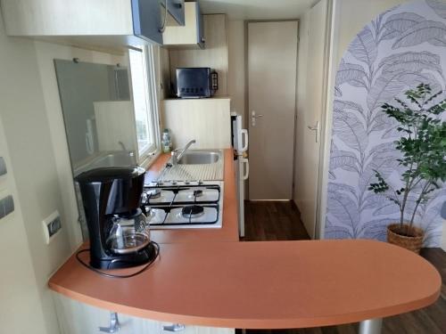 a kitchen with a counter with a coffee maker on it at Mobil home YANN in Sainte-Croix-de-Verdon
