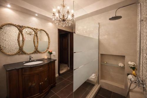a bathroom with a sink and a mirror at Royal stylish view apartment in Koropi