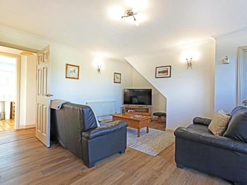 a living room with two couches and a tv at Tom Putt in Ledbury