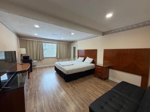 a hotel room with a bed and a desk at Skyline Inn in Mount Pocono