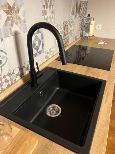 a black kitchen sink with a black faucet at Oasi di pace in Romano Canavese