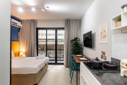 a small hotel room with a bed and a kitchen at Studio with Pool and Gym - DP203 in São Paulo
