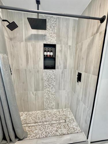 a bathroom with a shower with a glass door at HPThe Haus BOFA Stadium Spectrum Bojangles Dogs in Charlotte