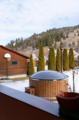 a hot tub in the backyard of a house at Pensiunea Bucur in Dămuc