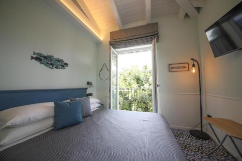 a bedroom with a bed and a sliding glass door at Tenuta Bellelli in Castellabate