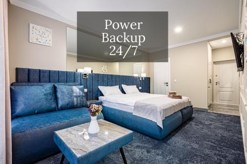 a bedroom with a bed and a blue couch at ApartReserve Avtorskiy Aparthotel in Ivano-Frankivsk