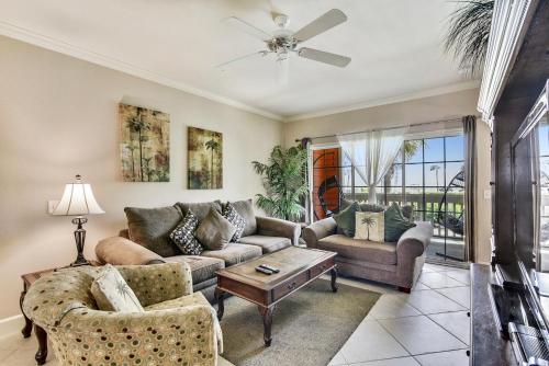a living room with a couch and a table at Dawn 824-Sea n Swim in Galveston