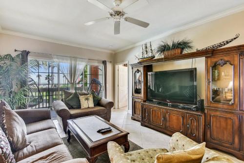 a living room with a large entertainment center and a tv at Dawn 824-Sea n Swim in Galveston