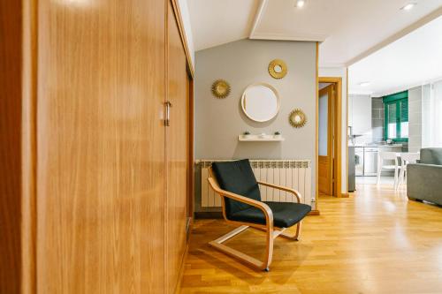 a room with a chair and a living room at adrimarcangas in Cangas de Onís