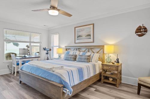 a bedroom with a bed and a desk at Oceanfront luxury, private pool & beach access! in Holden Beach