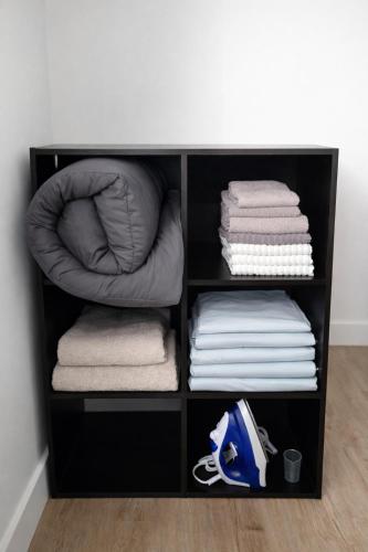 a black shelf with towels and a pile of towels at Dwntwn Detroit Wlk to DMC Arena WSU FordField in Detroit