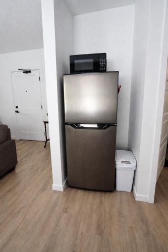 a small refrigerator with a microwave on top of it at Dwntwn Detroit Wlk to DMC Arena WSU FordField in Detroit