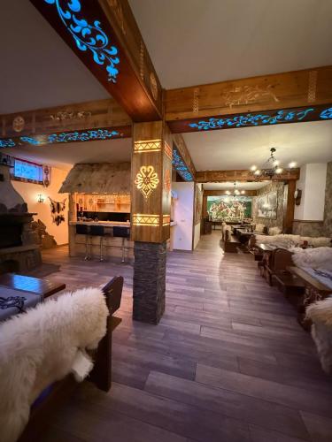 a living room with a large room with a fireplace at Czarna Turnia -ZAKOPANE in Zakopane