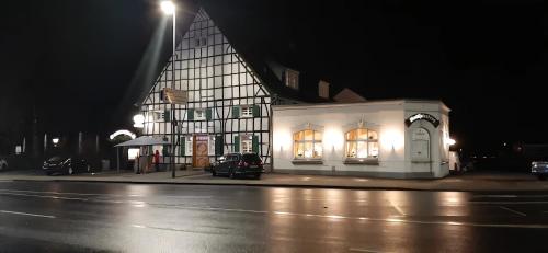 a black and white building on a street at night at Westfalenkrug in Wuppertal