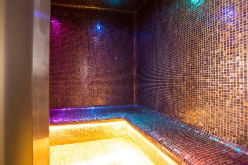 a room with a tub with colored lights on it at Hotel Cetus in Cetara