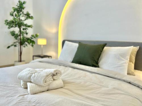 a bedroom with a bed with towels on it at Panoramic Ocean View Villa in Is-Swieqi