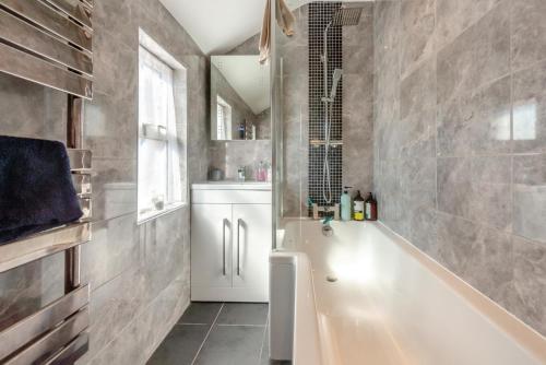 a bathroom with a tub and a sink at 3 Bed in Lincoln oc-a30207 in Lincoln