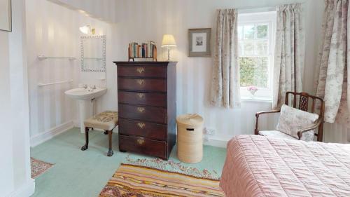 a bedroom with a bed and a sink and a dresser at 4 Bed in Abersoch oc-trefab in Abersoch