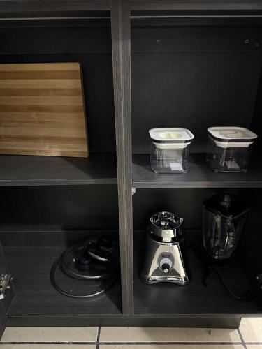 a shelf with a blender and other kitchen items at AeroloftGT in Estación Pamplona