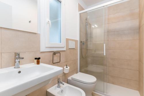 a bathroom with a sink and a toilet and a shower at Ostuni Torre Pozzelle Open Air in Ostuni Costa Merlata