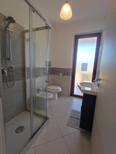 a bathroom with a shower and a toilet and a sink at Villa Rosetta in Villaggio Mosè