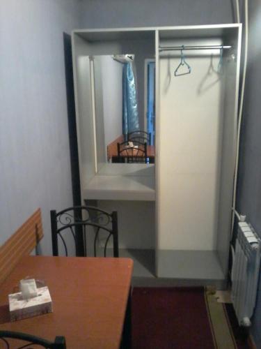 a mirror in a room with a table and a chair at ARBA hotel in Yerevan